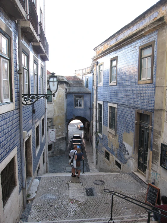 a couple of people standing on a concrete walkway