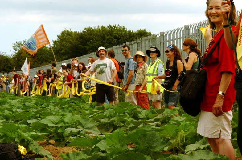 a group of people gathered together around plants