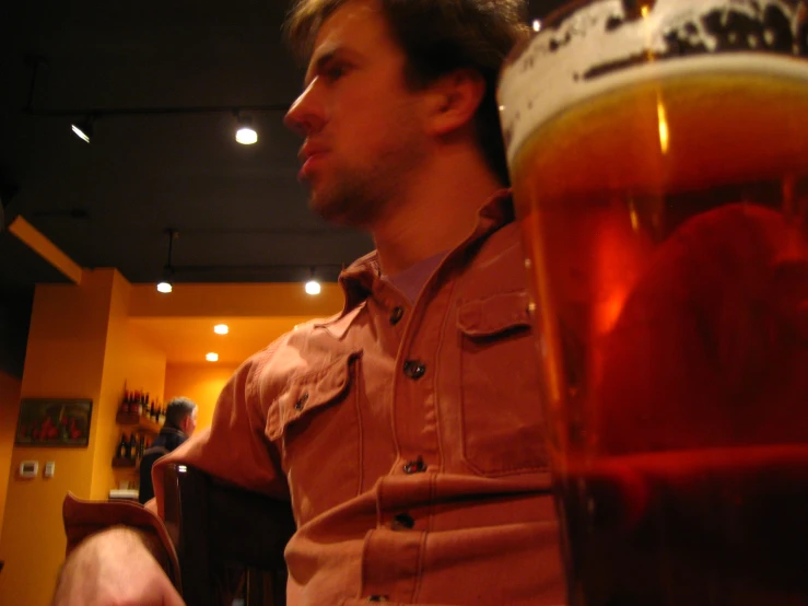 a man is sitting in front of beer in a pub