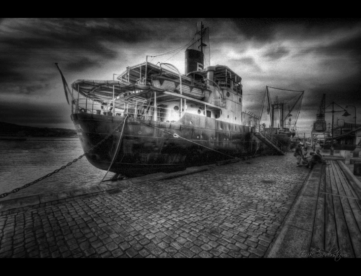 a ship sitting in the water at the shore