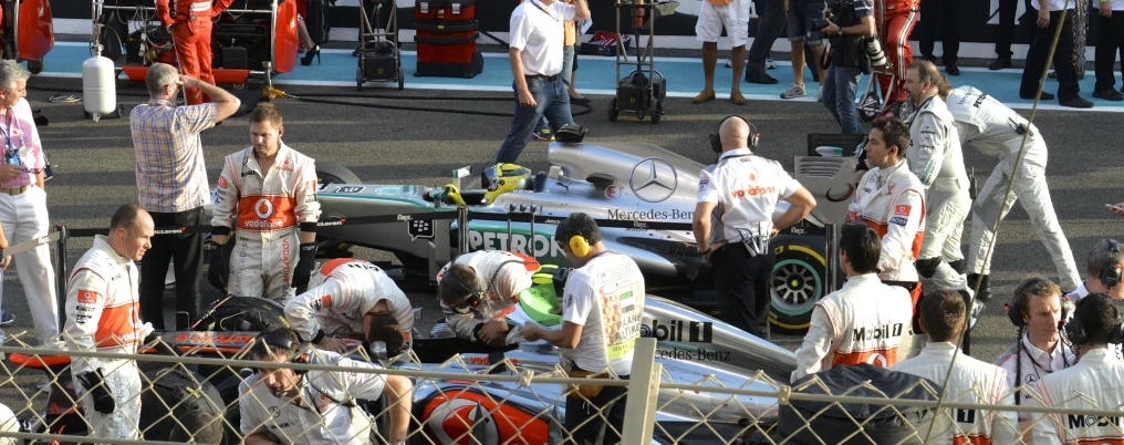 a race car being taken off the track by an engineer