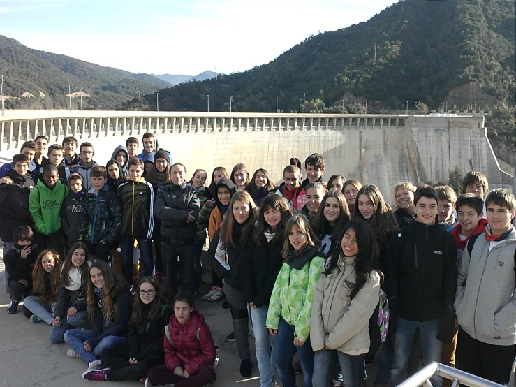 a group of students gathered by the hoover dam