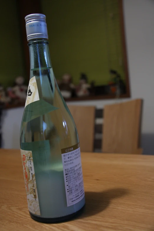 a bottle is sitting on a table near chairs