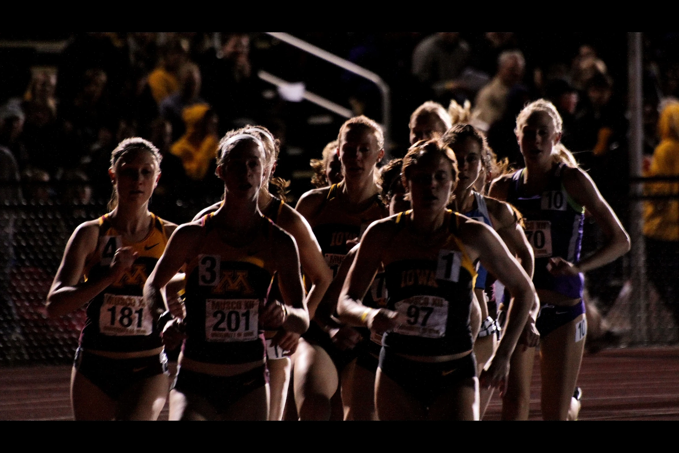 a group of athletes walking away from the camera