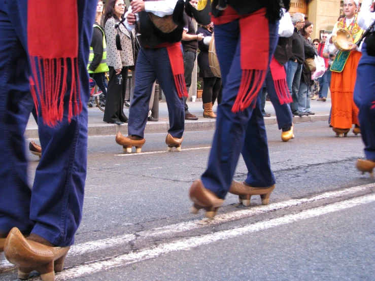 several people are riding skateboards down the street