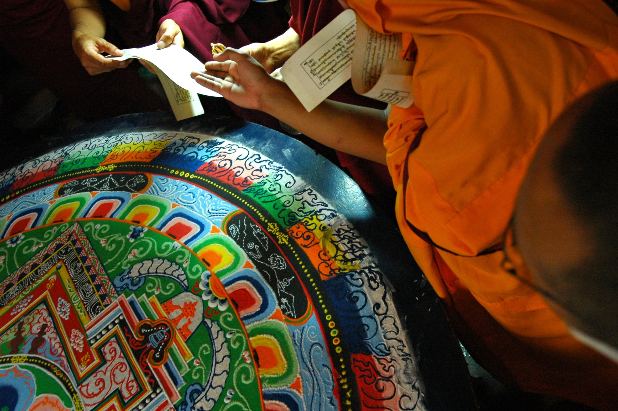 buddhist monks writing on paper on a plate