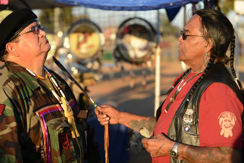 an old couple of men standing next to each other