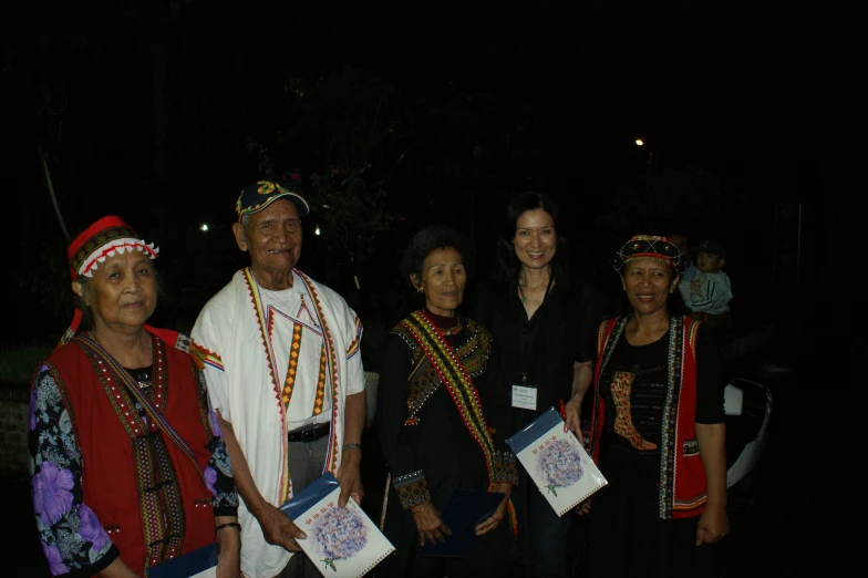 people with a priest in traditional dress and headdreses