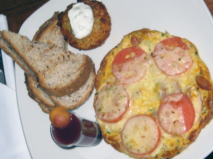 an open faced pizza topped with toppings on a plate