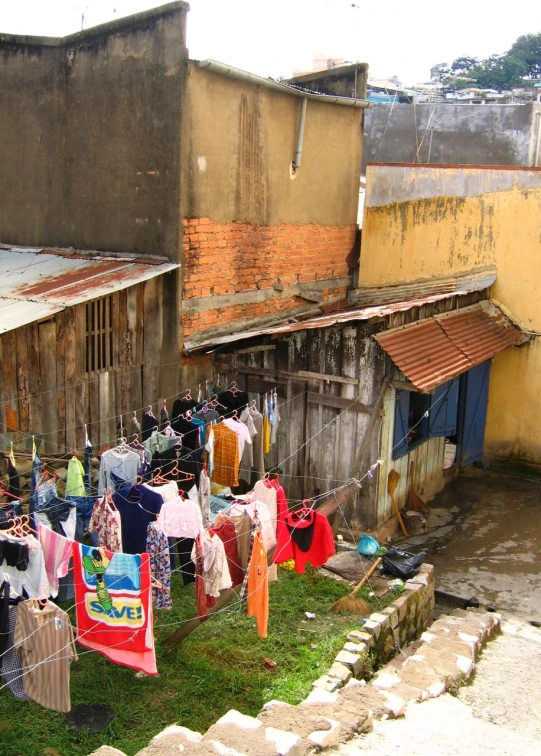 there are clothes on the clothes line outside of this house