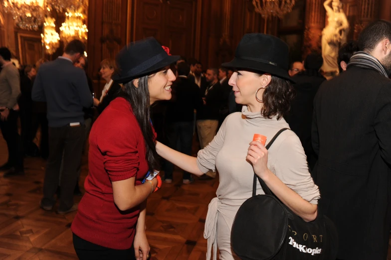 two ladies dancing at a ball in a building