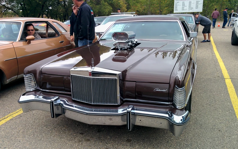 a brown old style car with chrome decoration