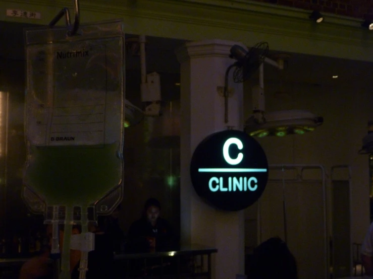 a sign for a clinic in front of a bar