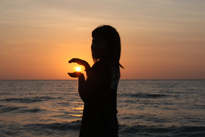 silhouette of a person on the beach at sunset