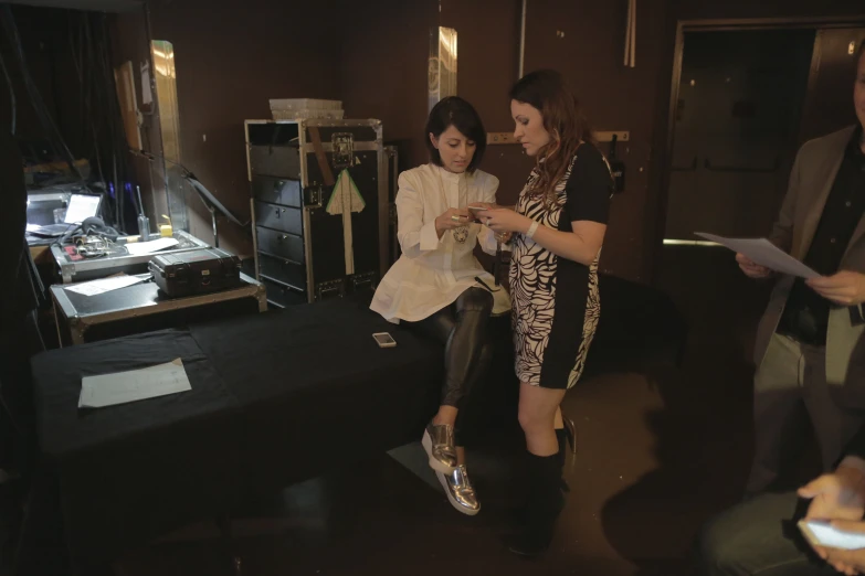 two women standing in a living room area