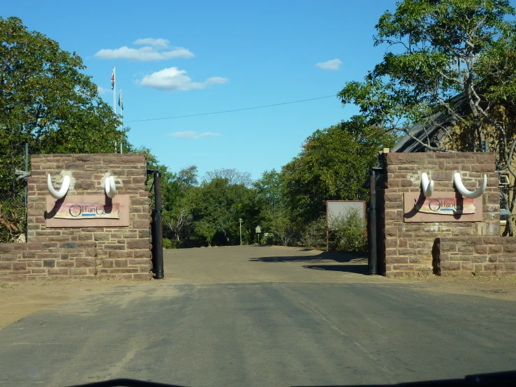 the street is paved and has several brown brick barriers on each side of it