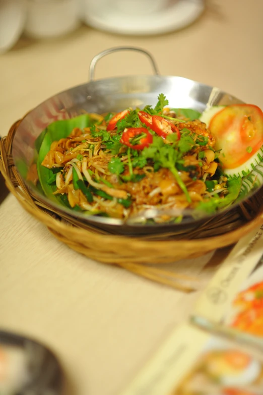 an asian stir fried vegetable dish in a metal bowl