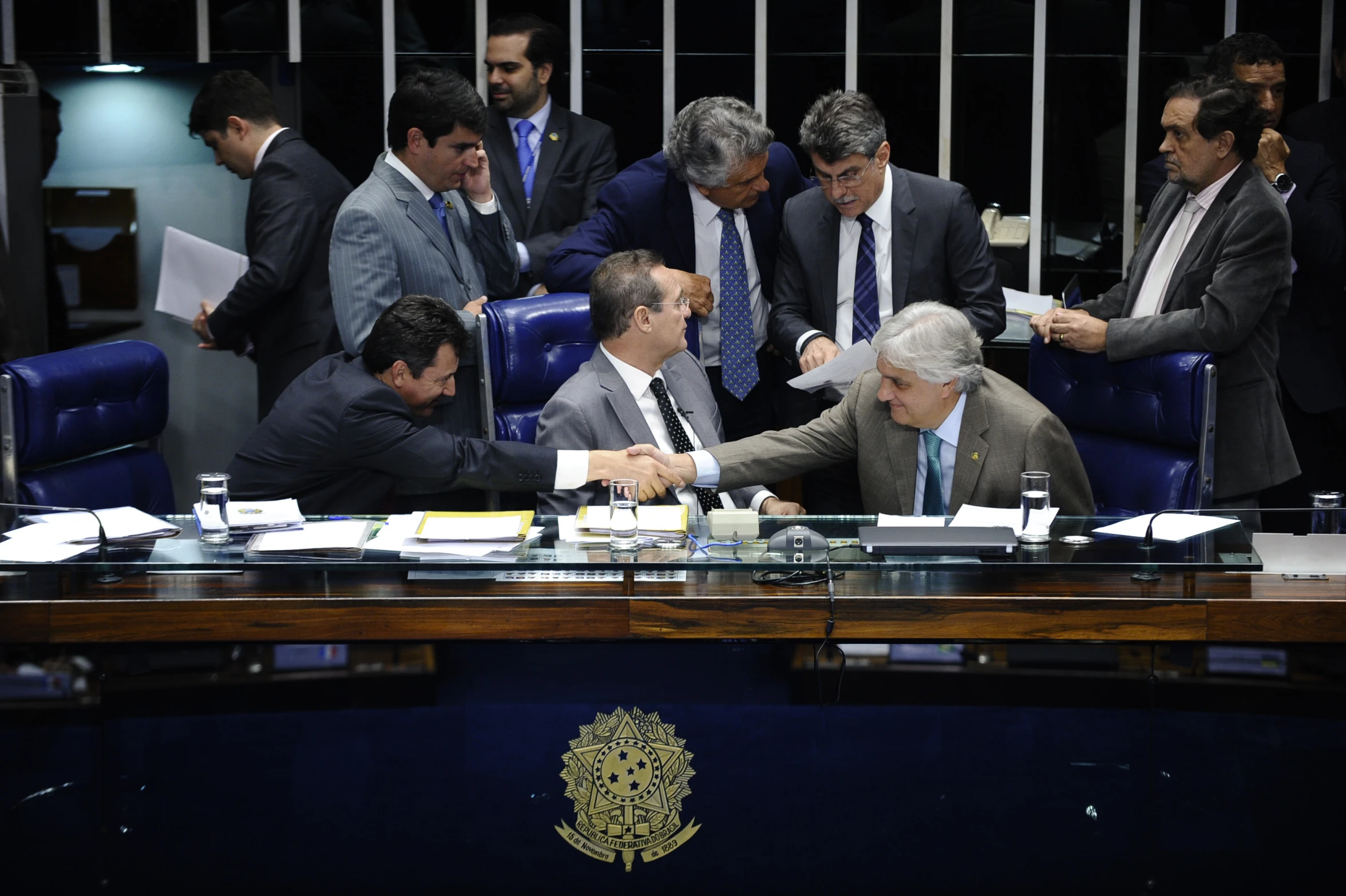 some men in suits and ties are having a meeting