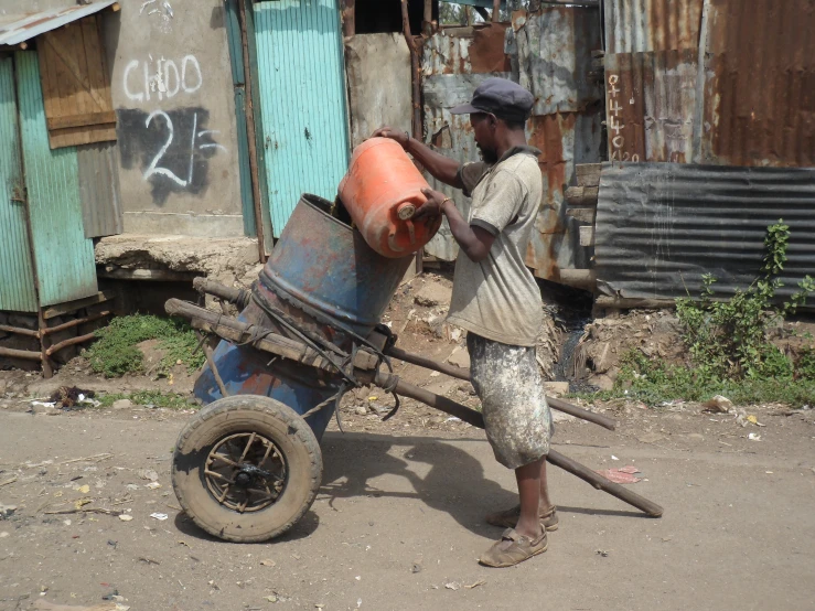 a man using an outdoor wheel to pull soing