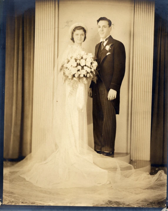 a bride and groom pose for a pograph