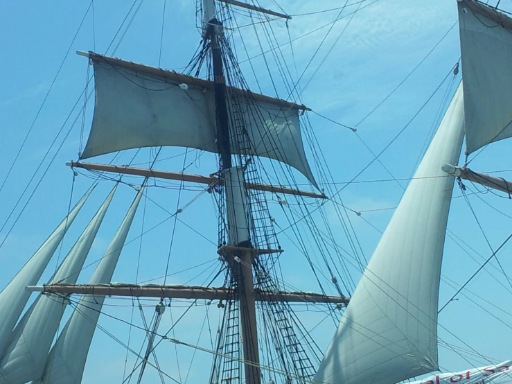 an image of a ship with sails on the water