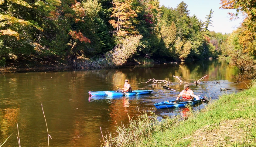 a group of people in canoes on the side of a lake