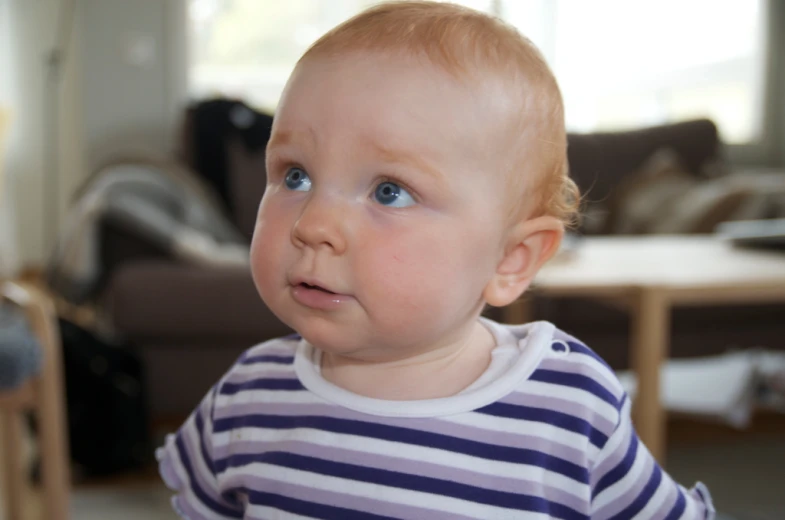 a young child with blue eyes looking up