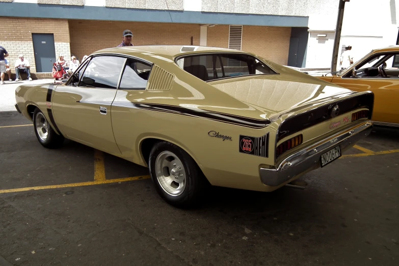 a tan muscle car in a parking lot