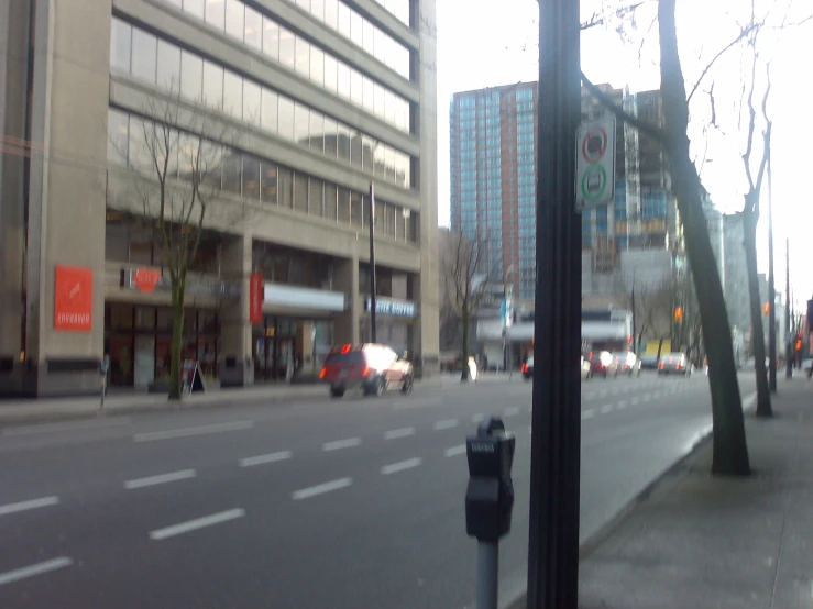 a city street with tall buildings in the background