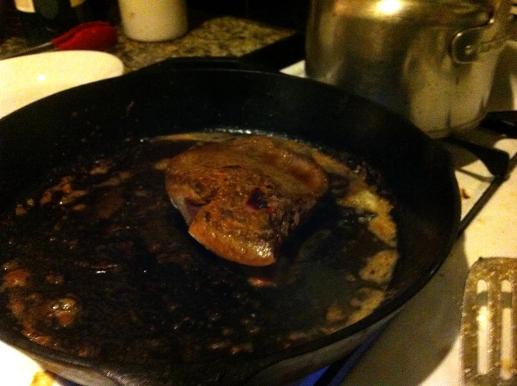 there is food cooking in a pan on the stove