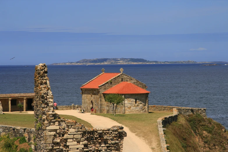 a stone house next to the ocean