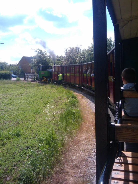 a boy that is sitting on a train