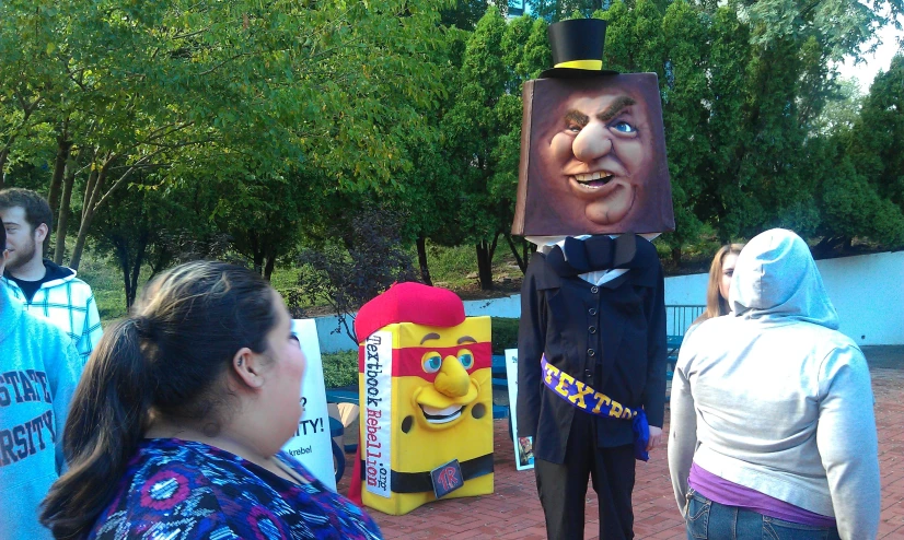 people standing in front of a large cardboard picture