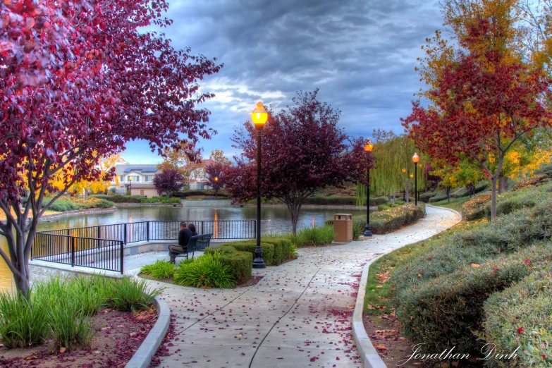 a paved walkway with a path next to water