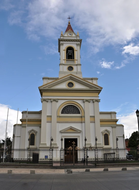 a church with a tall tower under blue skies