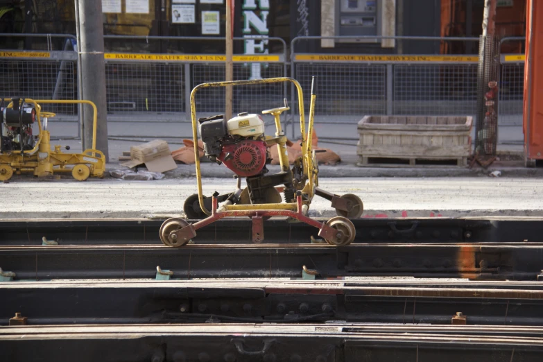 a small engine on top of a trolley car on some train tracks