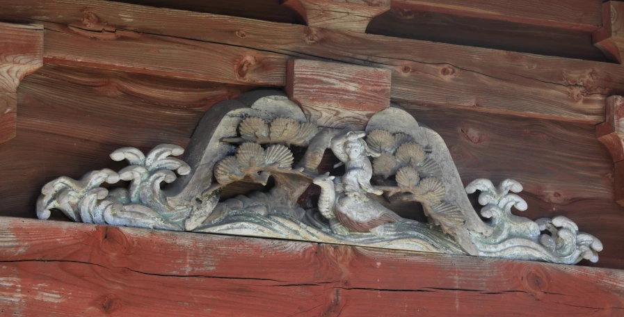 carvings on the side of wooden beams with wood and plaster