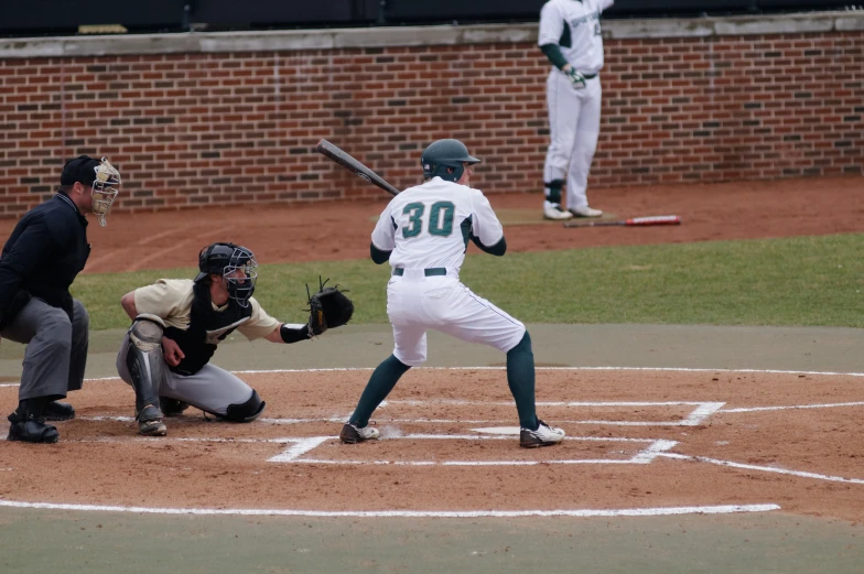 a baseball player is in the process of swinging a bat