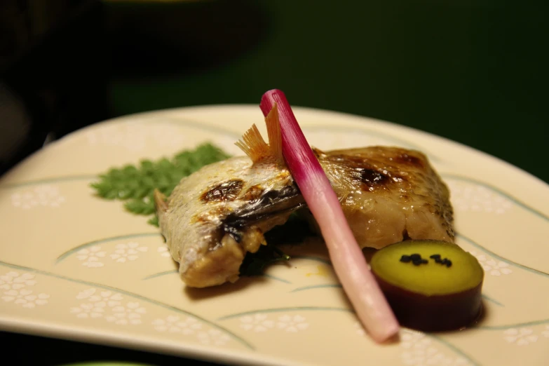 a plate of food with a green radish