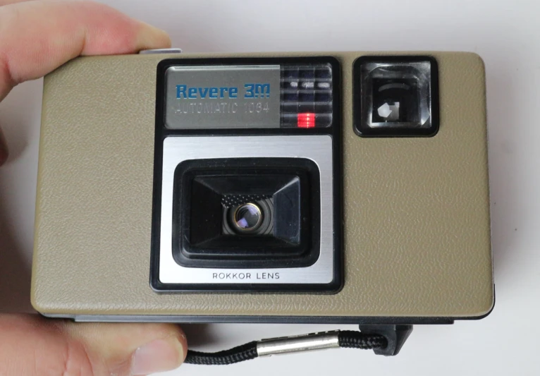 an old polaroid camera held in someone's hand