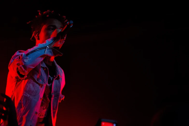 a man with dreadlocks and an umbrella on stage