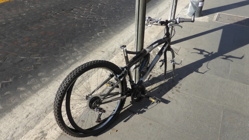 a bicycle sitting at the top of a parking pole