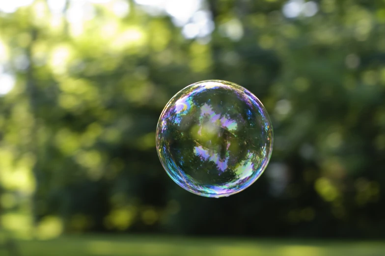 a bubbles with a green area and trees in the background