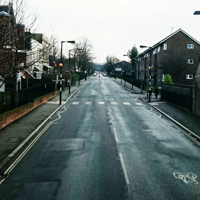 a road that is lined with brick buildings