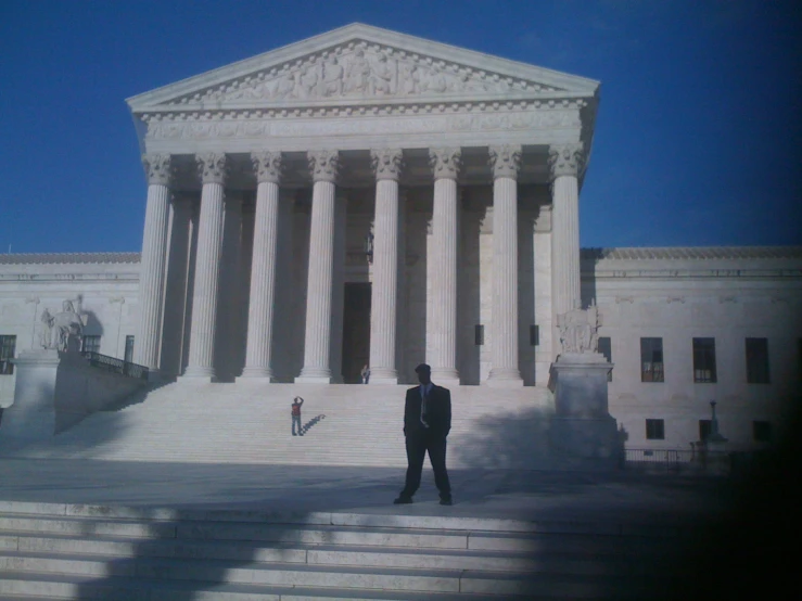 this is an image of a man standing in front of a courthouse