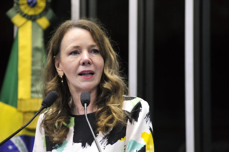 a woman standing at a podium with a microphone