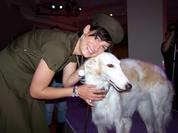 a woman posing for a picture with her pet dog