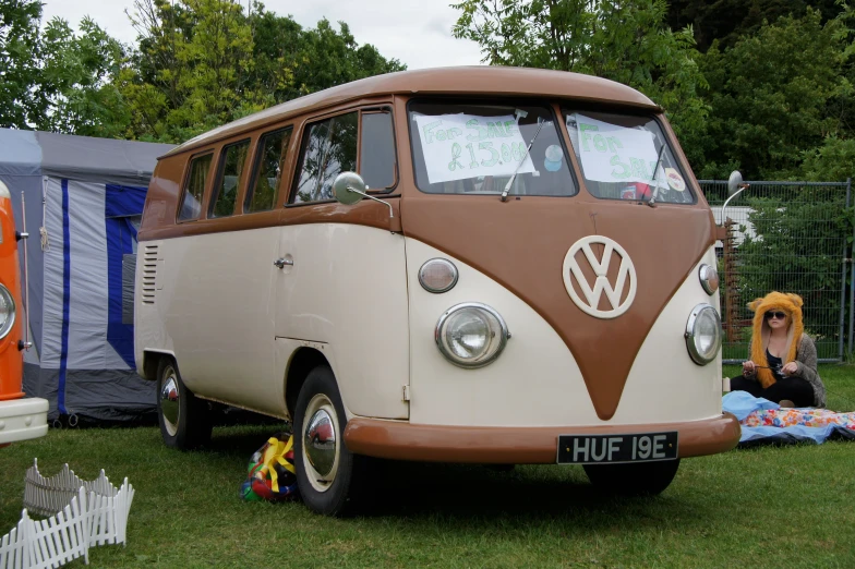 a small vw bus sitting in the grass