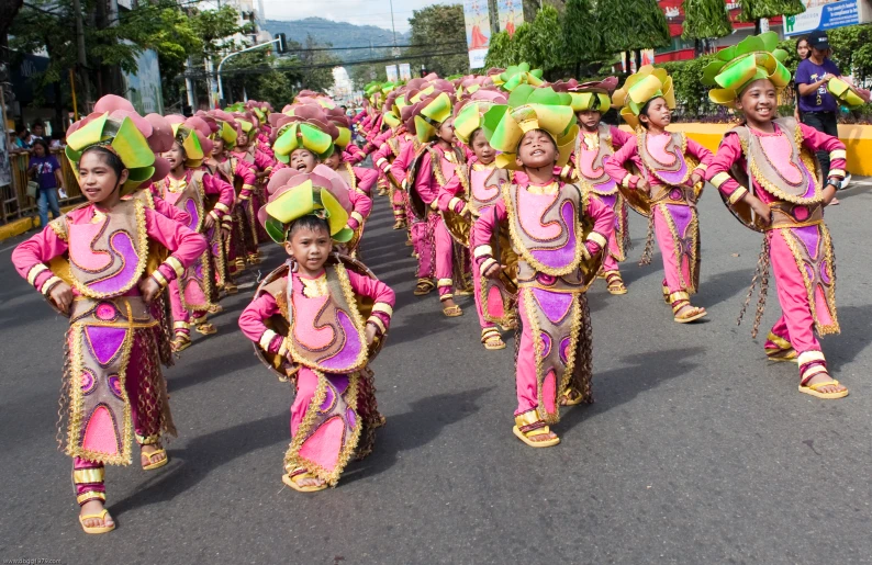 a bunch of people in bright pink outfits marching