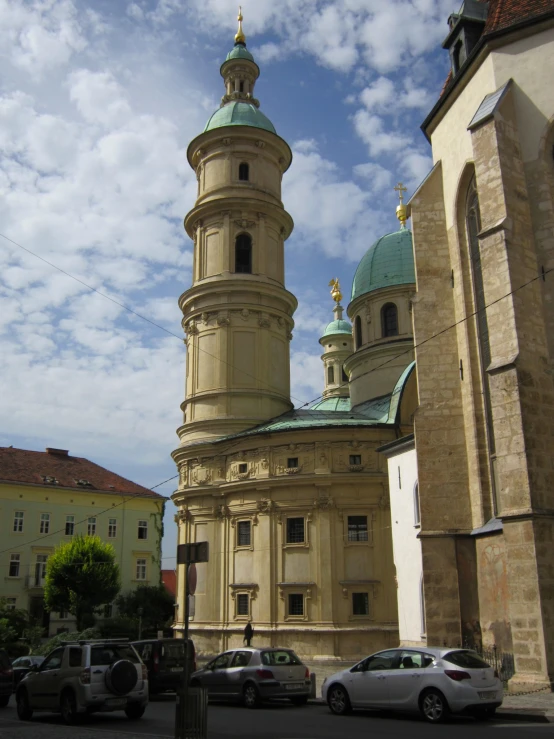 a tall white building with two towers in the background